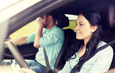 Image showing woman driving car and man covering face with palm