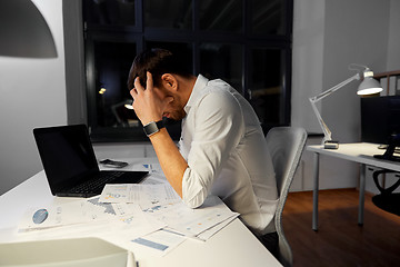 Image showing businessman with papers working at night office