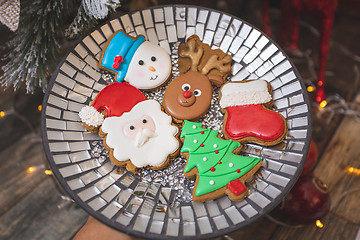 Image showing Iced gingerbread cookies by the Christmas tree