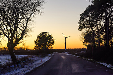 Image showing Wind turbine by sunset by a countryroad