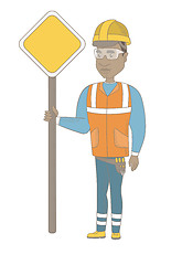 Image showing Young african road worker showing road sign.