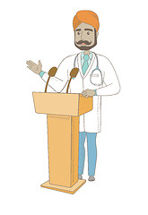 Image showing Indian doctor giving a speech from tribune.