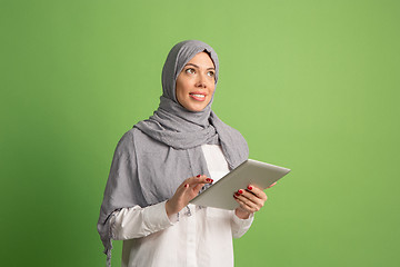 Image showing Happy arab woman in hijab. Portrait of smiling girl, posing at studio background