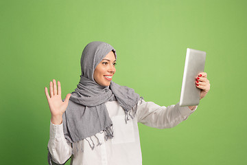 Image showing Happy arab woman in hijab. Portrait of smiling girl, posing at studio background