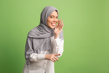 Image showing Happy arab woman in hijab. Portrait of smiling girl, posing at studio background