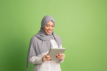 Image showing Happy arab woman in hijab. Portrait of smiling girl, posing at studio background