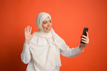 Image showing Happy arab woman in hijab. Portrait of smiling girl, posing at studio background