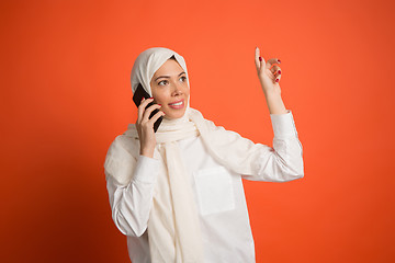 Image showing Happy arab woman in hijab. Portrait of smiling girl, posing at studio background