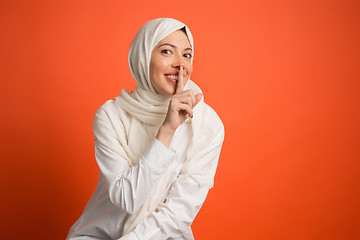 Image showing Happy arab woman in hijab. Portrait of smiling girl, posing at studio background