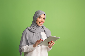 Image showing Happy arab woman in hijab. Portrait of smiling girl, posing at studio background