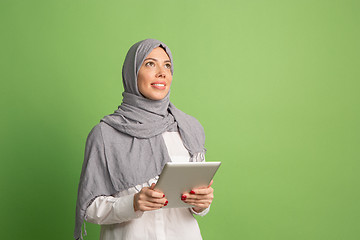 Image showing Happy arab woman in hijab. Portrait of smiling girl, posing at studio background