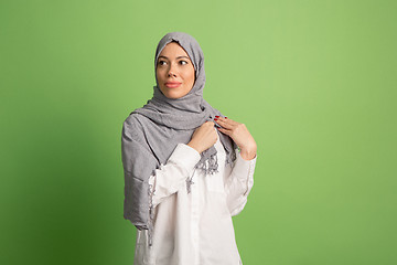 Image showing Happy arab woman in hijab. Portrait of smiling girl, posing at studio background