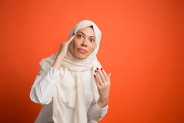 Image showing Argue, arguing concept. arab woman in hijab. Portrait of girl, posing at studio background