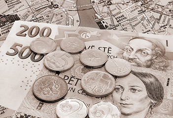 Image showing Czech money on Prague map with landmarks
