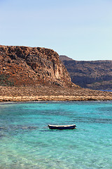 Image showing Sea view with clear turquoise water and empty boat, Crete island