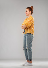 Image showing red haired teenage girl in shirt and torn jeans