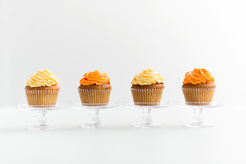 Image showing cupcakes with frosting on confectionery stands