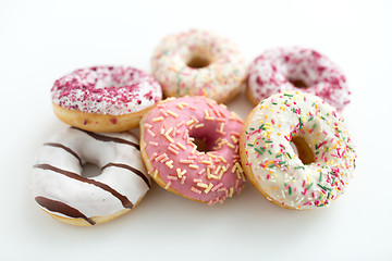 Image showing close up of glazed donuts on white table