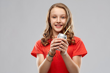 Image showing teenage girl holding can of soda with paper straw