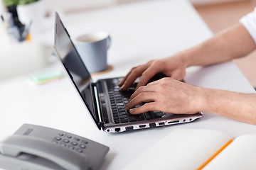 Image showing hands typing on laptop computer at office