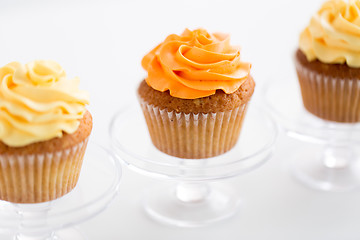 Image showing cupcakes with frosting on confectionery stands