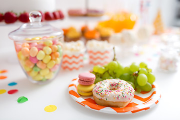 Image showing grapes, macarons and donut on party table