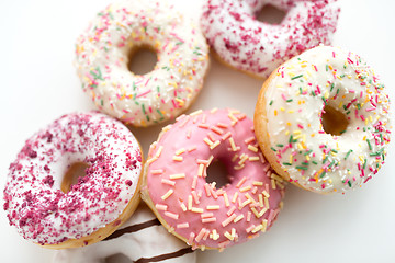 Image showing close up of glazed donuts on white table