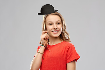 Image showing smiling teenage girl with bowler hat party prop