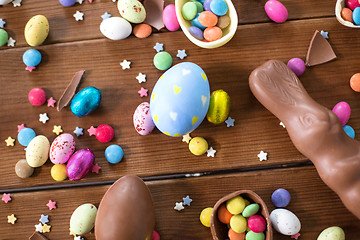 Image showing chocolate eggs, easter bunny and candies on wood