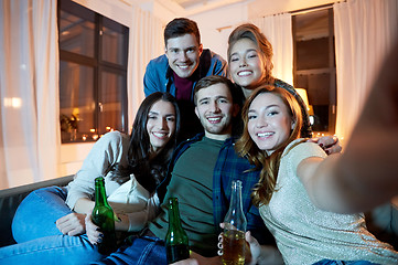 Image showing happy friends taking selfie at home party