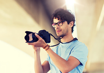 Image showing photographer with digital camera shooting in city