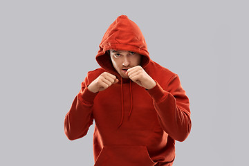 Image showing man in red hoodie fighting with fists or boxing