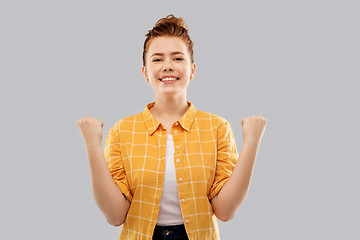 Image showing happy red haired teenage girl celebrating success