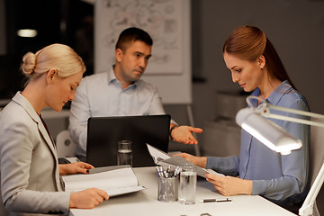 Image showing business team with laptop working at night office