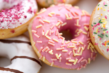 Image showing close up of glazed donuts on white table