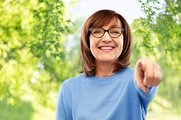 Image showing senior woman in glasses pointing finger to you