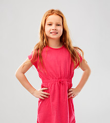 Image showing smiling red haired girl posing in pink dress