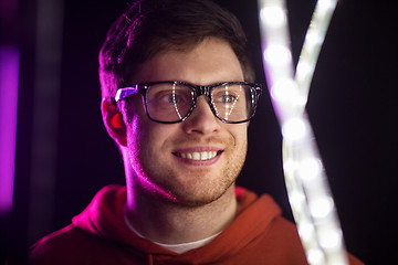 Image showing portrait of man in glasses over neon lights