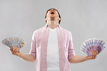 Image showing screaming young man with euro and dollar money