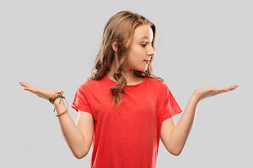Image showing smiling teenage girl holding empty hand