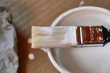 Image showing Paint brush on a can of white wall paint