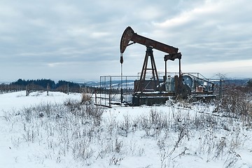 Image showing Oil well on a winter landscape