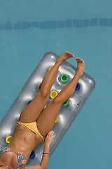 Image showing young woman lying on inflatable sunbed