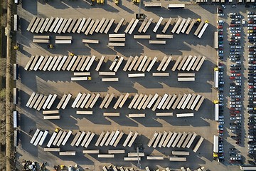 Image showing Line of trucks and trailers from above at a cargo terminal