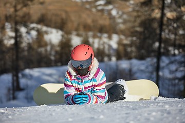 Image showing Snowboarder resting in the snow