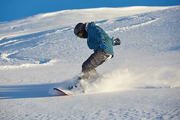 Image showing Snowboarding in fresh powder snow