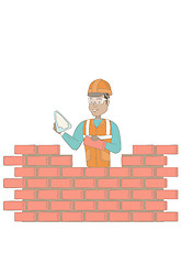 Image showing Young bricklayer working with spatula and brick.