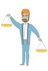 Image showing Hindu businessman holding balance scale.