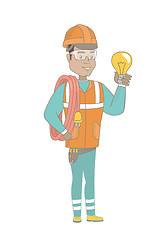 Image showing Young hispanic electrician holding a lightbulb.