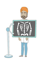 Image showing Indian roentgenologist during x ray procedure.
